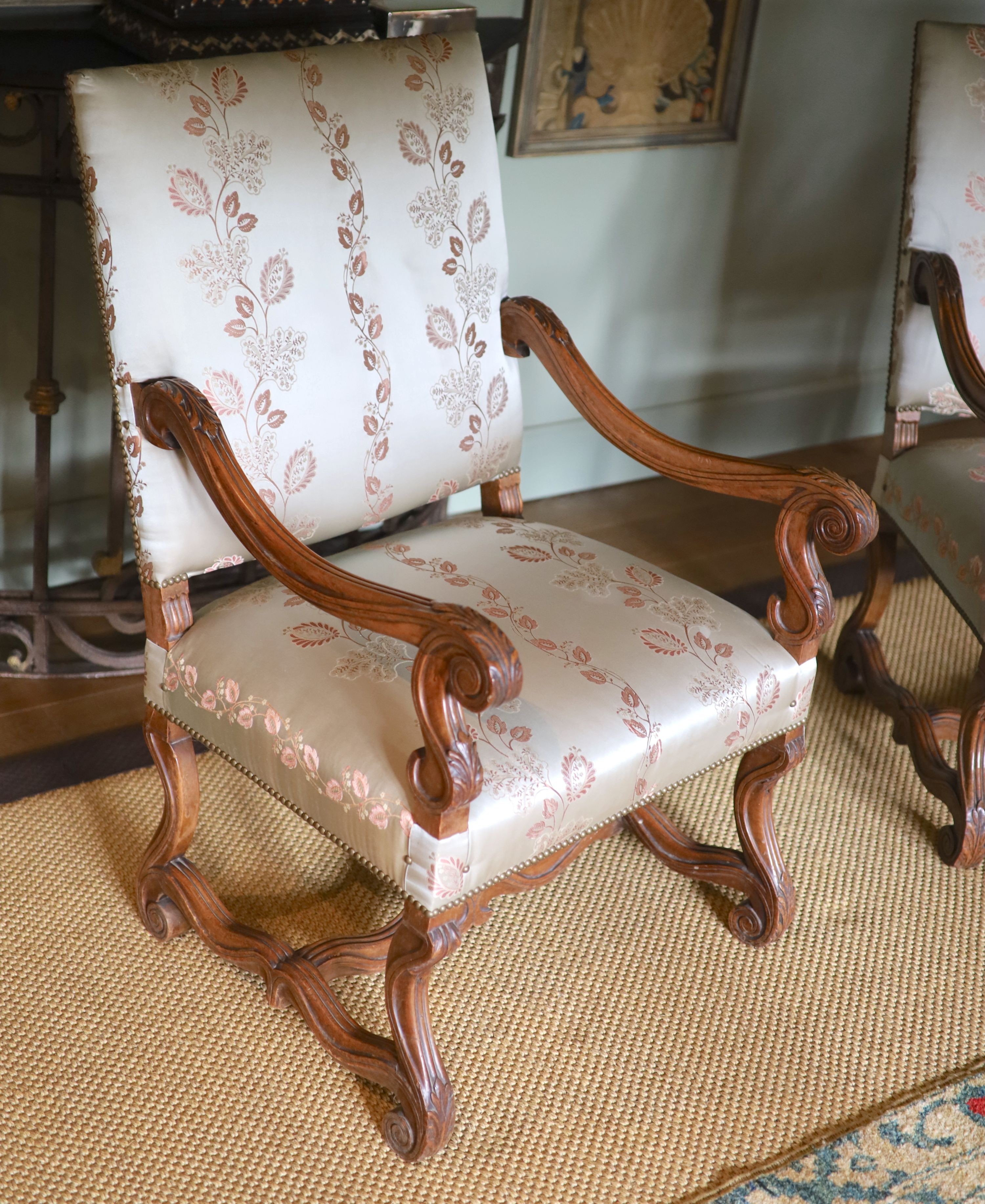 A pair of French carved walnut fauteuils, with machine embroidered Eau de Nil silk upholstery, width 66cm height 106cm